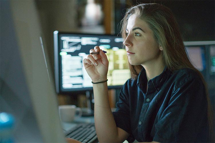 woman thinking pen in hand