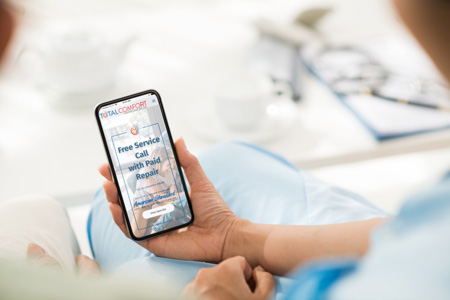 Checking Total comfort's website on phone