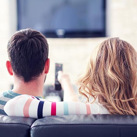 husband and wife watching tv