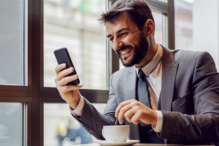 man smiling at phone